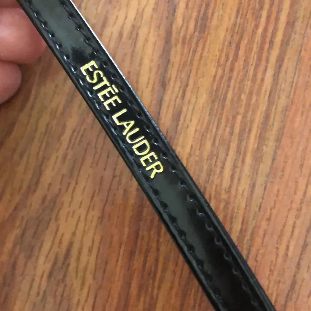 Estee Lauder Harpers Bizarre black and yellow cosmetic case.